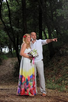 portrait of a young couple walking in the forest