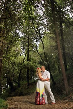 portrait of a young couple walking in the forest