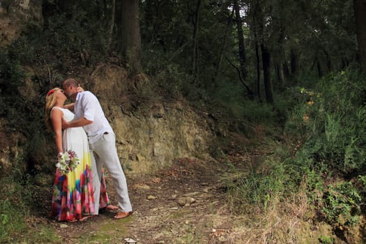 portrait of a young couple walking in the forest