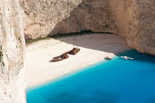 beautiful white beach with shipwreck in a greek island