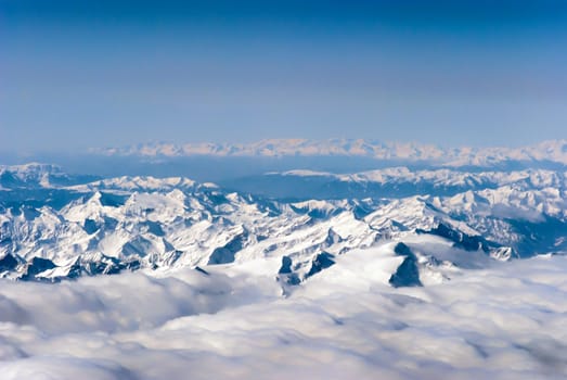 aerial view of mountains and clouds on top 