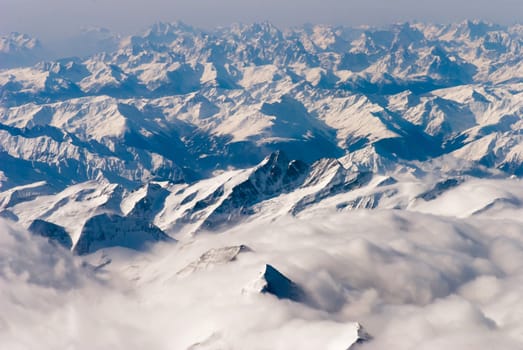 aerial view of mountains and clouds on top 