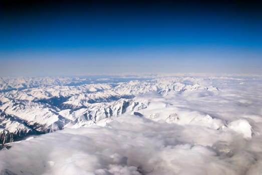 aerial view of mountains and clouds on top 