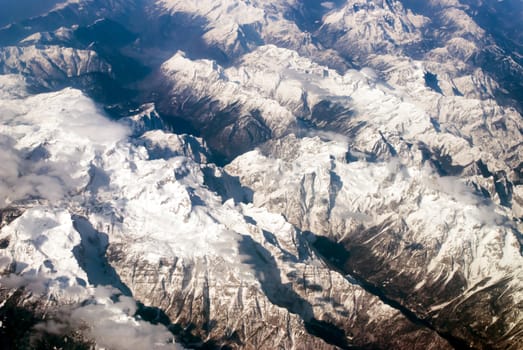 aerial view of mountains and clouds on top 