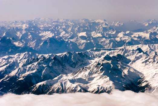aerial view of mountains and clouds on top 
