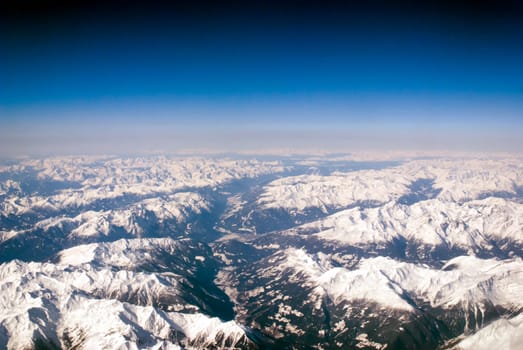 aerial view of mountains and clouds on top 