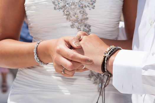 hands of wedding couple changing rings