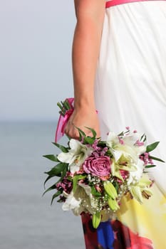 close up of a female  hand holding a flower bouquet 