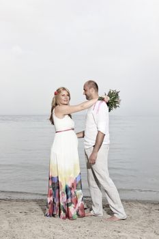 portrait of a young couple at the beach having romance
