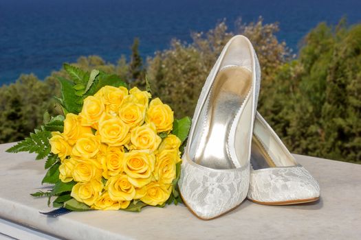 bridal shoes and wedding flower bouquet