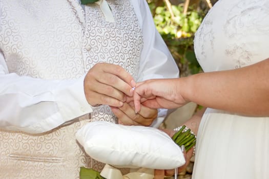 close up of bride and groom hands during wedding cermony