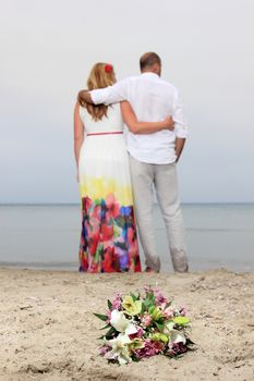 portrait of a young couple at the beach having romance
