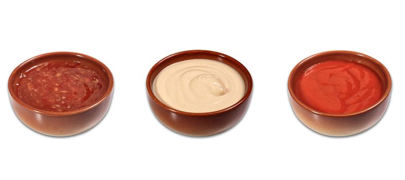 mix of sauces ona small bowls isolated on a white background