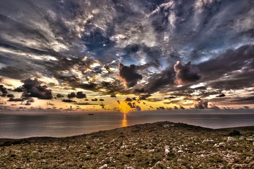 amazing sunset with clouds in a greek island