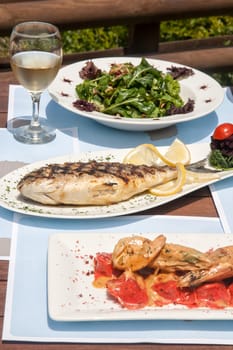closeup of a healthy seafood on a table for two by the sea
