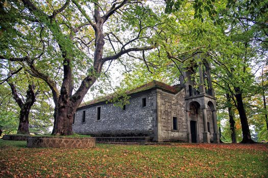 small church on forest with big trees   