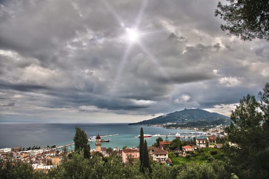 stuning landscape of a greek island with cloudy sky and sun with star shape