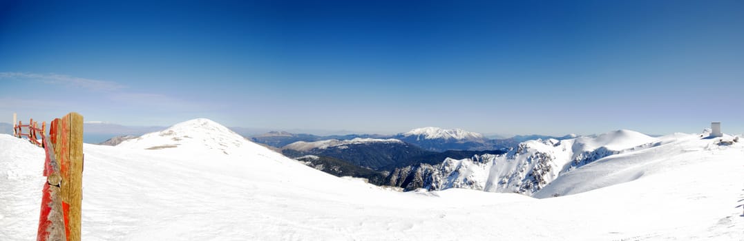 top of the mountain with snow on a sunny day