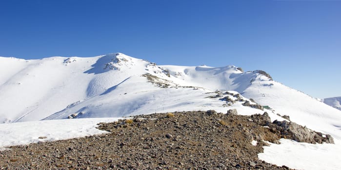 top of the mountain with snow on a sunny day