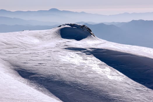 top of the mountain with snow on a sunny day