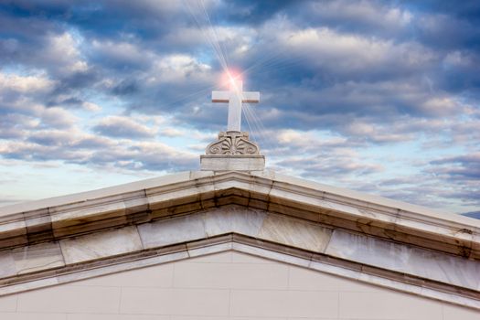 top of an old church against the blue cloudy sky 