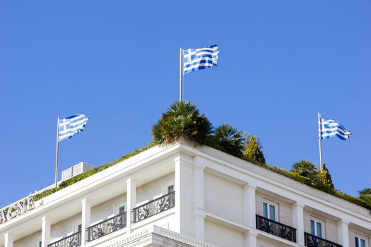 greek flags on the roof garden of a building