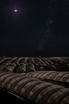 silo on a planet and the milky way in the background with light from the sky