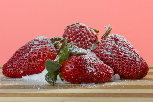 closeup of fresh strawberries with sugar powder on top 