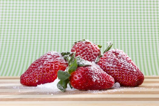 closeup of fresh strawberries with sugar powder on top 