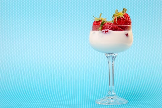 fresh strawberries on a glass filled with cream 