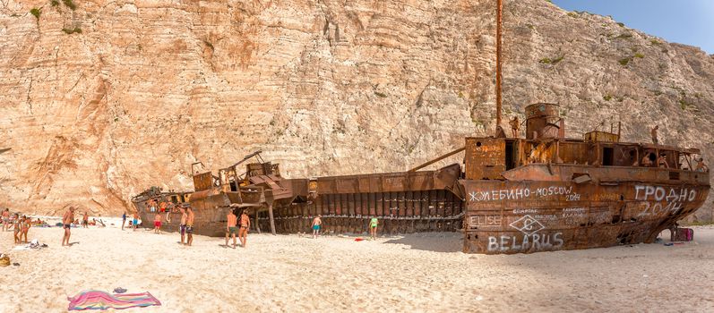 tourists enjoy the sun in the beautiful beach with shipwreck in the island of Zante,29 August 2014,Greece