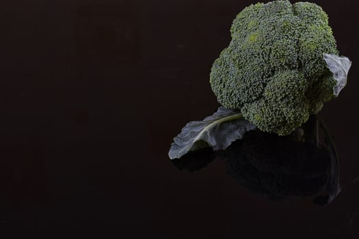 Fresh broccoli on dark wooden table background