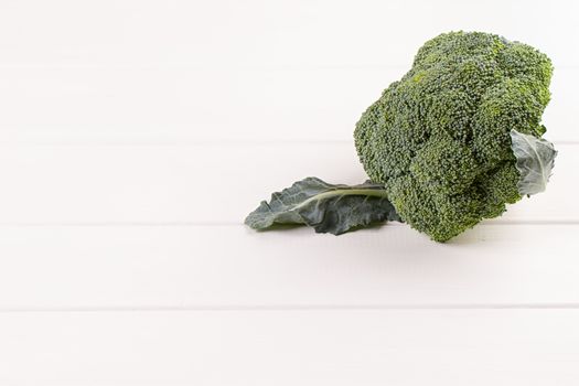 Fresh broccoli on white wooden table background