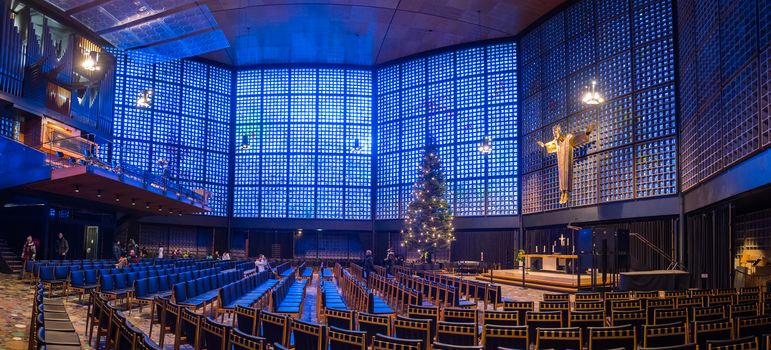 BERLIN,GERMANY - JANUARY 3, 2016: Interior of the memorial church with the gold statue of Jesus and the wall made from blue glass pieces