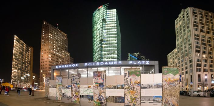 BERLIN, GERMANY - JANUARY 4 2016: Postdamer Platz with a monument fron the wall and modern buildings on the background at night