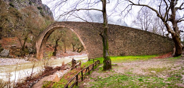 Arched stone bridge of Pyli in a rainy day,Thessaly, Greece