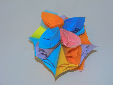 Origami from multi-colored pieces of paper on white background