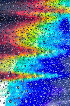 background with drops of water and a rainbow behind