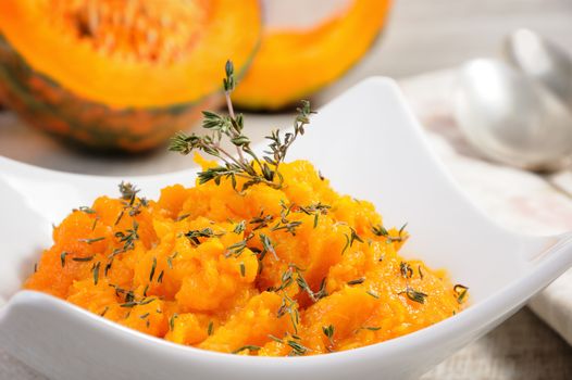 Baked pumpkin with a tender, juicy pulp flavored with thyme. Close-up.