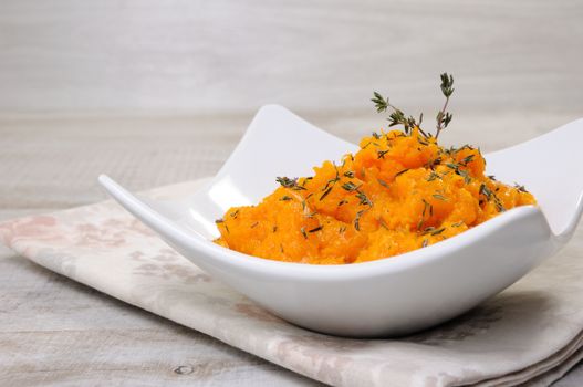 Baked pumpkin with a tender, juicy pulp flavored with thyme. Close-up.