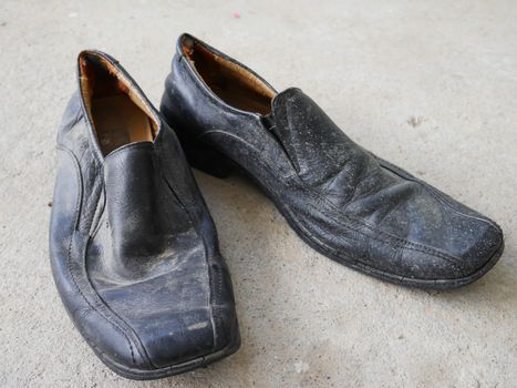 Old black shoe on the floor