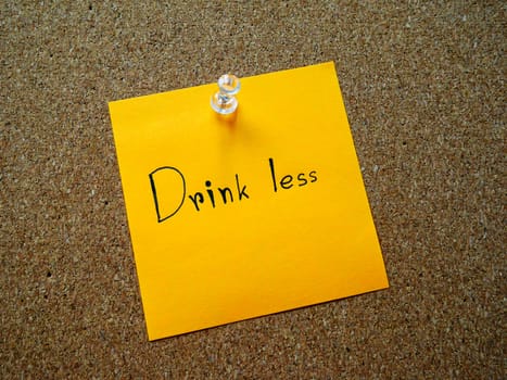 Writting "Drink less" on post it note for your healthy