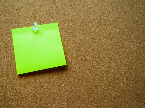Green post it note on wooden board with copy space