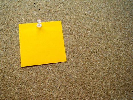 Orange post it note on wooden board with copy space