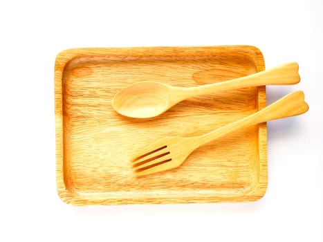 Wooden plate and spoon on white backgound
