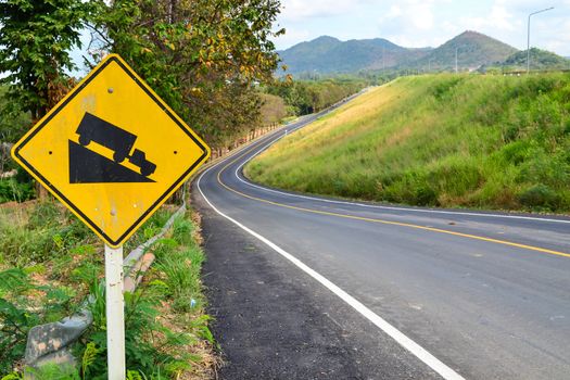 Steep hill descent sign side beautiful road