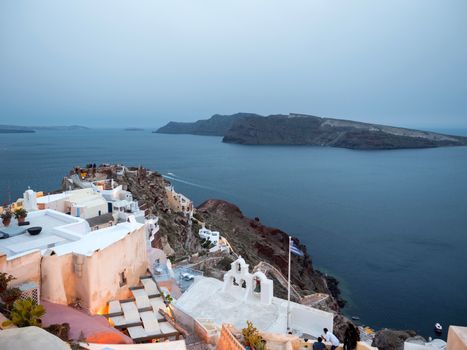 Small white houses with lights late in the afternoon in Oia, Santorini island,Greece