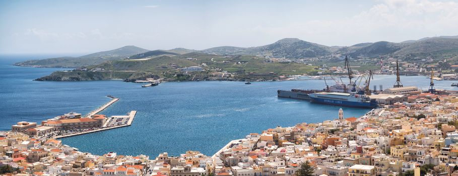 SYROS, GREECE - APRIL 10, 2016: View of Syros town and the port with beautiful buildings and houses in a sunny day