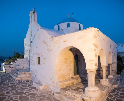 Small white church by the sea in Paros, Greece