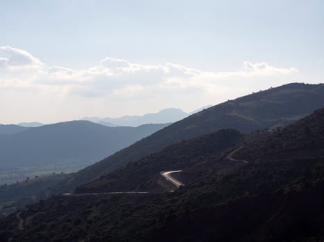 Road crossing the mountains as reflecting the sun light